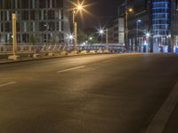 the city streets are empty at night and there is traffic in the distance, all on either side the road