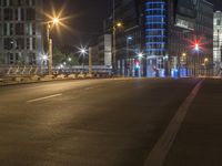 the city streets are empty at night and there is traffic in the distance, all on either side the road