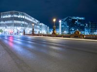 a very long exposure of a city street at night with buildings and lights on the background