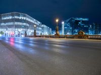 a very long exposure of a city street at night with buildings and lights on the background