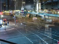 an intersection with buses, lights and shops at night time on the road side of a city street