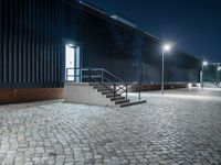 brick walkway that has steps and stairs to the outside of it, with lights on all of them