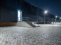 brick walkway that has steps and stairs to the outside of it, with lights on all of them