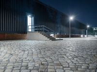 brick walkway that has steps and stairs to the outside of it, with lights on all of them