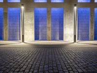 the side walk on an empty brick building in a blue light place on a sunny day