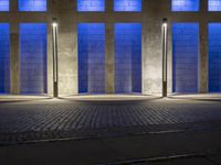 the side walk on an empty brick building in a blue light place on a sunny day