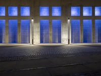 the side walk on an empty brick building in a blue light place on a sunny day