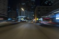 motion blurs the image from a car at night as it moves along the street