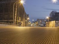 the lights shine on a street that runs over a bridge and into some buildings in a city