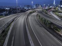 a highway that is very long and winding through the city at night time and during twilight