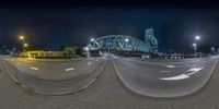 a blurry photograph shows the highway and bridge of this city at night in two dimensional