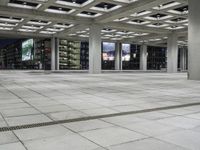 a large empty square on the outside of a building at night time with many windows