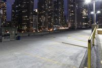 a large parking lot in a city next to tall buildings at night in the dark