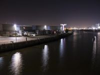 a long exposure photograph of the skyline at night with the lights on and reflection on the water