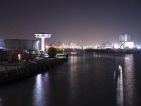 a long exposure photograph of the skyline at night with the lights on and reflection on the water