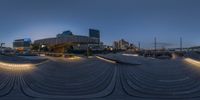 a circular image shows the light on the city street at night, reflecting off the floor and into the ground