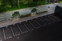 this is an aerial view of a large parking lot with cars on the street and a car