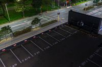 this is an aerial view of a large parking lot with cars on the street and a car