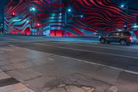 an american flag building with red and silver lights at night in a city street or street corner