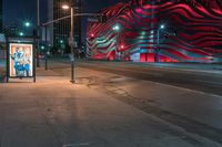 an american flag building with red and silver lights at night in a city street or street corner