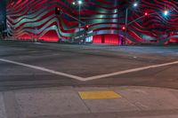 an american flag building with red and silver lights at night in a city street or street corner