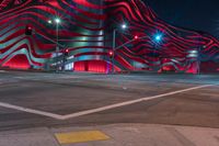 an american flag building with red and silver lights at night in a city street or street corner