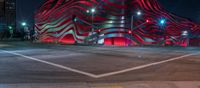 an american flag building with red and silver lights at night in a city street or street corner