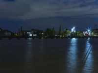 a night time photo shows the skyline as well as the water and building lights in the background