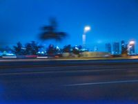 a blurry image of the highway in night time with lights reflecting off of the asphalt