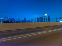 a blurry image of the highway in night time with lights reflecting off of the asphalt