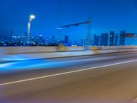 a blurry image of the highway in night time with lights reflecting off of the asphalt