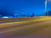 a blurry image of the highway in night time with lights reflecting off of the asphalt