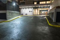 street corner in night with car and bicycle racket at entrance by side of building