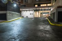 street corner in night with car and bicycle racket at entrance by side of building