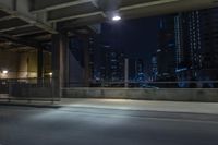 cars travelling down an empty highway with the city skyline visible in the background, along with an overpass