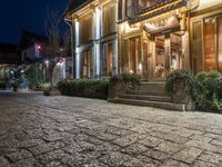 the cobblestones have some lights on in the dark and are illuminated by bright lights