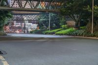 a city street with buildings and neon lights at night time in hong china as seen from an empty city highway