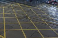 a yellow street sign sitting on the side of a road next to traffic lights and a curb