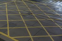 a yellow street sign sitting on the side of a road next to traffic lights and a curb