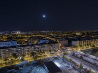 the town lights shine bright in this nighttime scene of madrid, with buses and cars on it