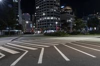 a night view of buildings and street lights, with a traffic light in the middle