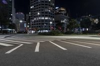 a night view of buildings and street lights, with a traffic light in the middle