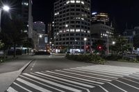 a night view of buildings and street lights, with a traffic light in the middle