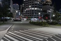 a night view of buildings and street lights, with a traffic light in the middle