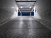 a walkway under construction with metal grates and door open onto the ocean shore at dusk