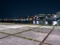 Nighttime Cityscape with Reflections on Water and Pier in Holland, Netherlands