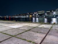 Nighttime Cityscape with Reflections on Water and Pier in Holland, Netherlands