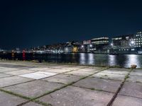 Nighttime Cityscape with Reflections on Water and Pier in Holland, Netherlands