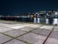 Nighttime Cityscape with Reflections on Water and Pier in Holland, Netherlands