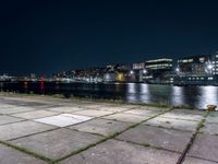 Nighttime Cityscape with Reflections on Water and Pier in Holland, Netherlands